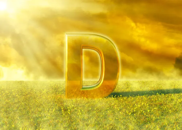 Vitamin D illuminated by the rays of the sun on grass. Sunlight is an excellent source of this nutrient that strengthens the immune system. 3D rendering.