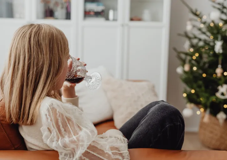 A woman on her couching enjoying her calm home for the holidays