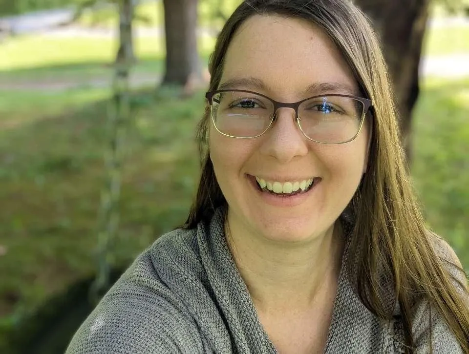“Couple reviewing finances together with hopeful expressions, symbolizing unity on the path to financial freedom.”