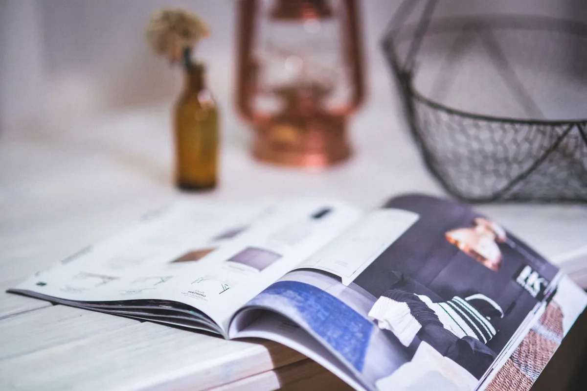 newspapers on table with coffee and flowers