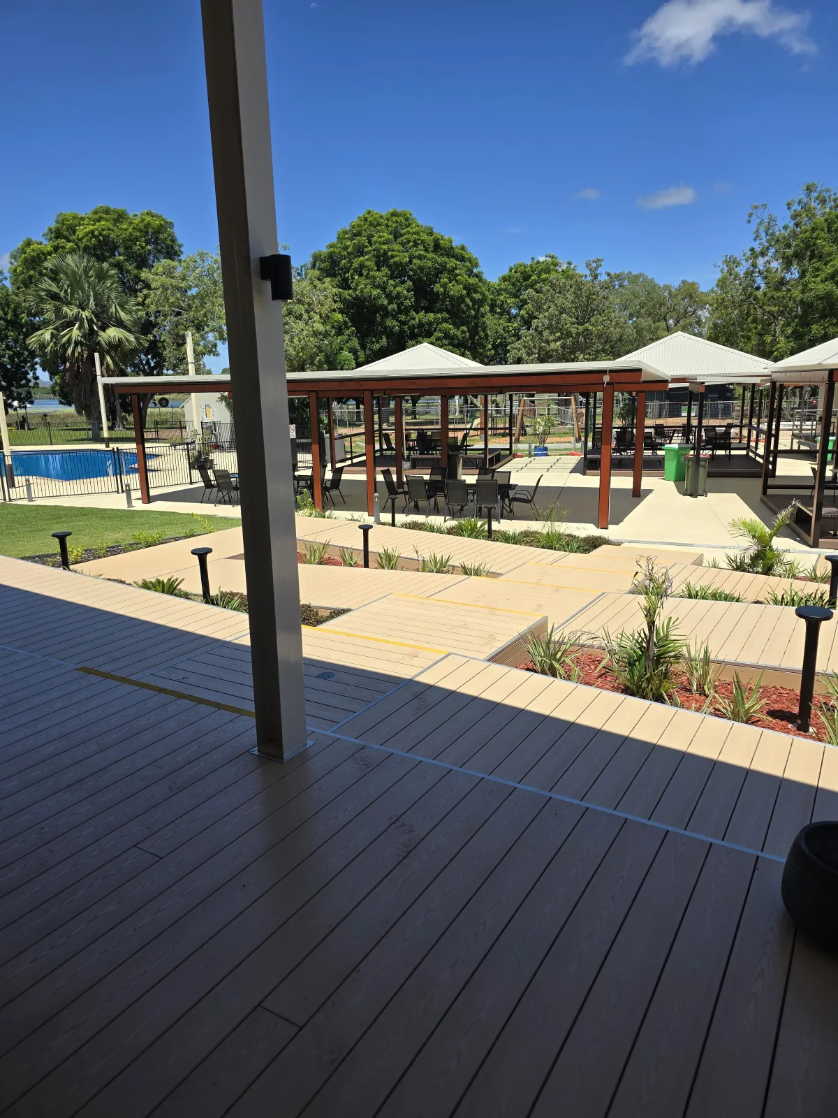Outdoor tables next to pool at Lilys Resort Kununurra