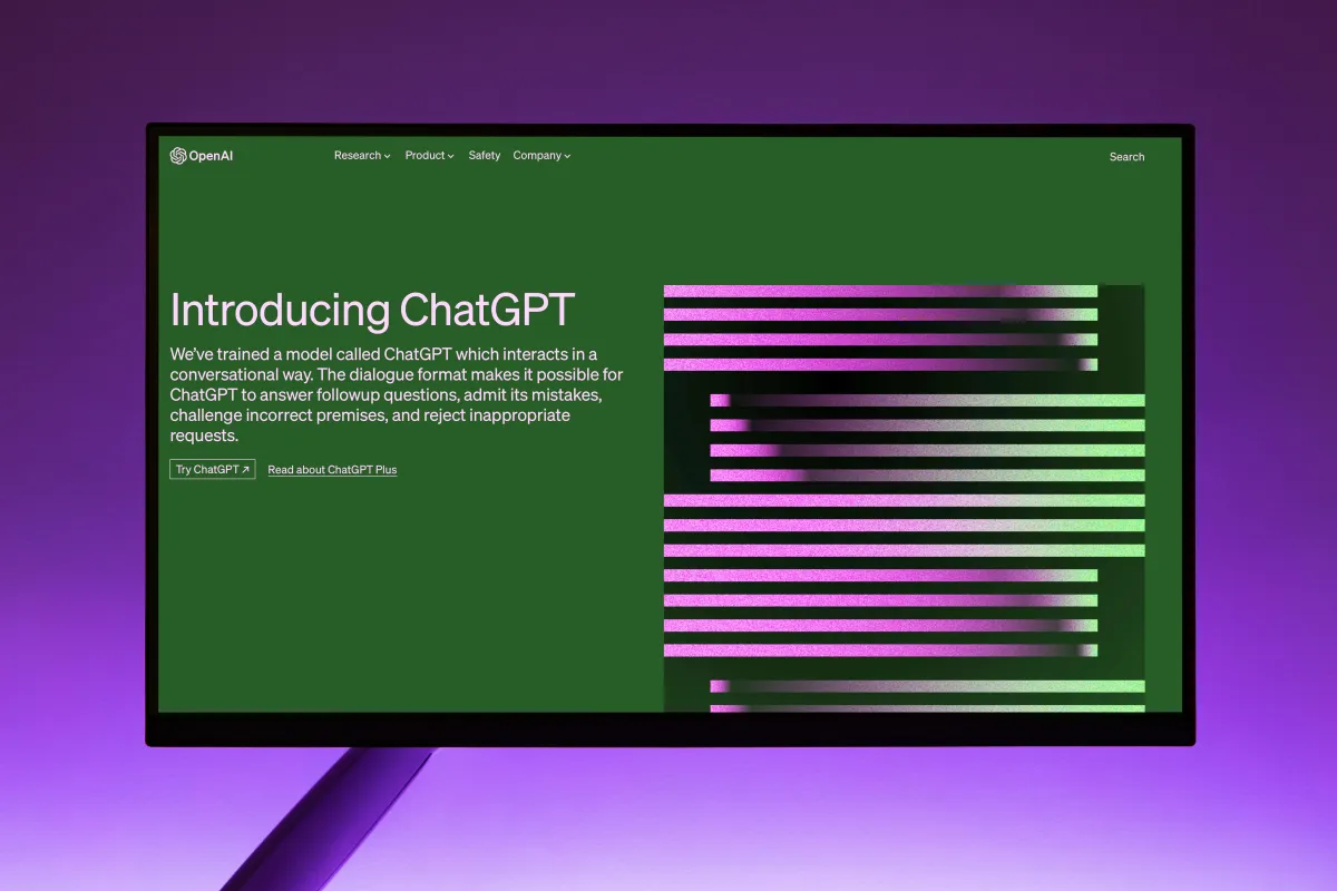 Green computer screen stating "Introducing ChatGPT" over purple background