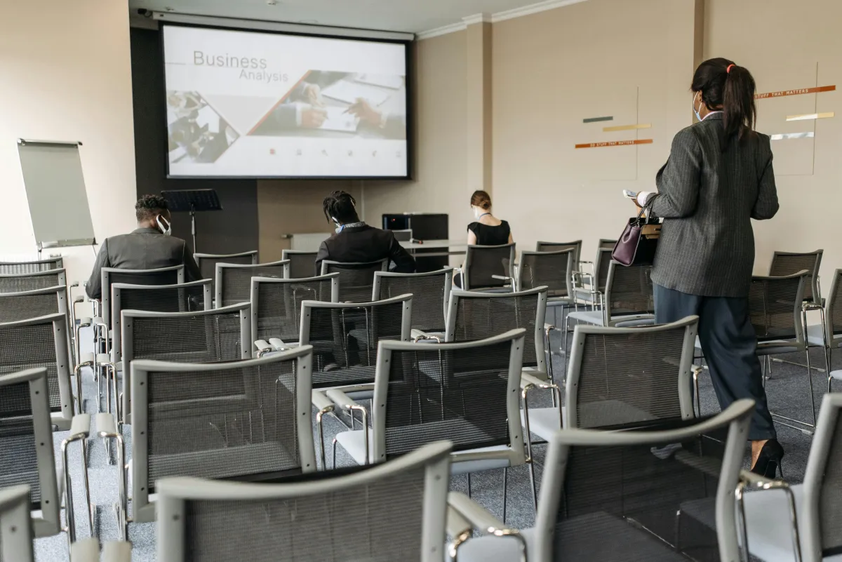 Presentation screen facing a room full of chairs.