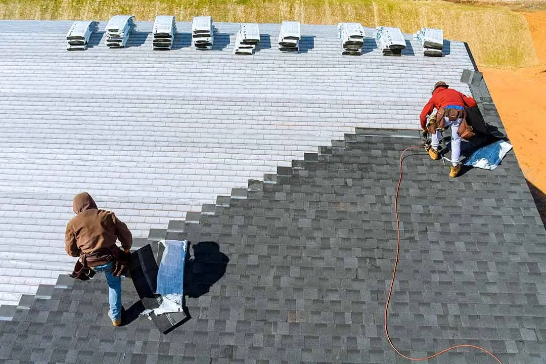 Installation of roof shingles.