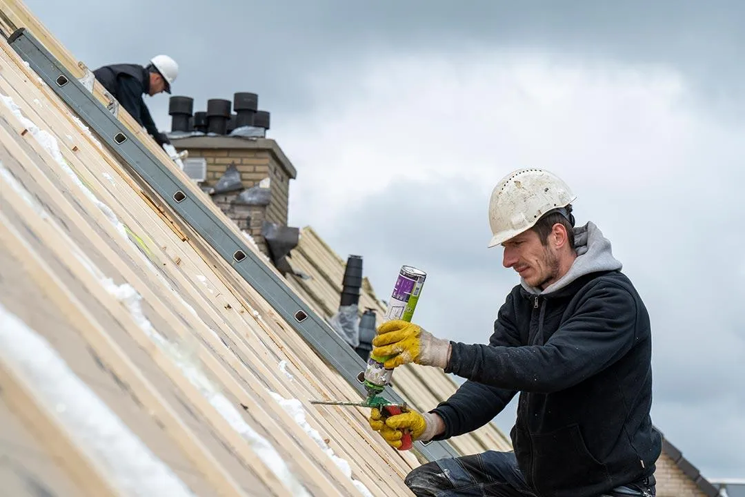 Roofing team at work on a residential roof.
