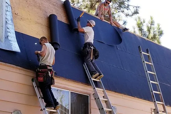professional roofers fixing a roof