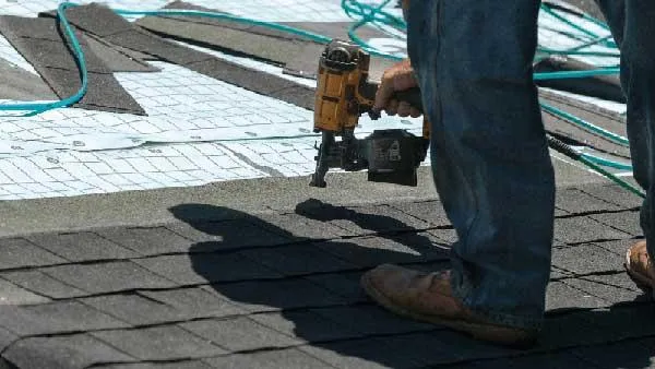 Roofer repairing a damage roof