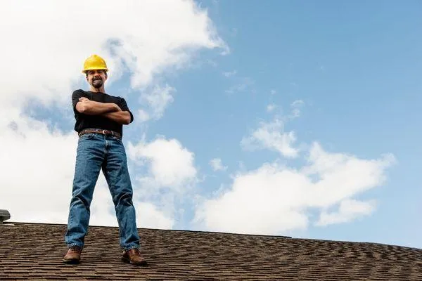 A roofer standing on a roof