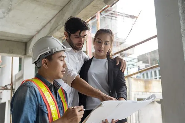 Professional roofer discussing roof replacement to homeowners