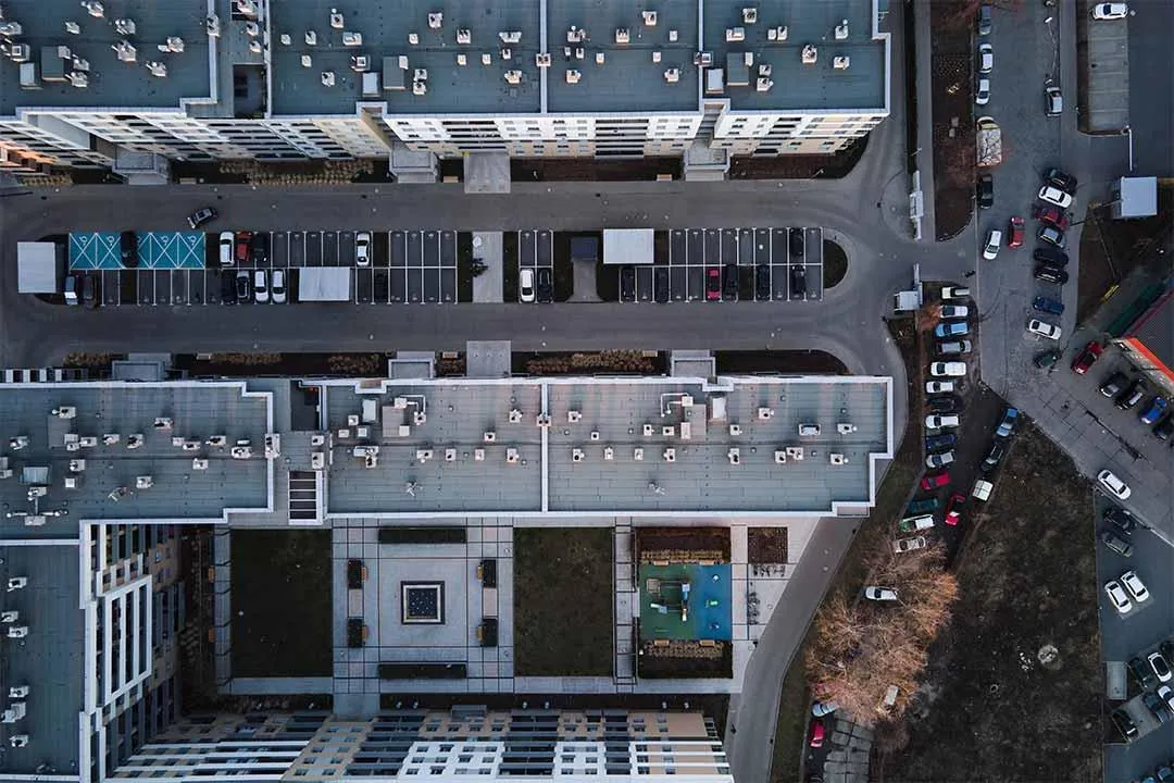 Aerial view of a city featuring various commercial buildings with flat roofs.