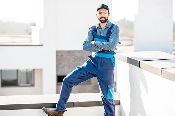 a roofing contractor posing in folded arms