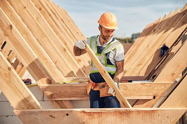 professional roofing contractor installing roof trusses