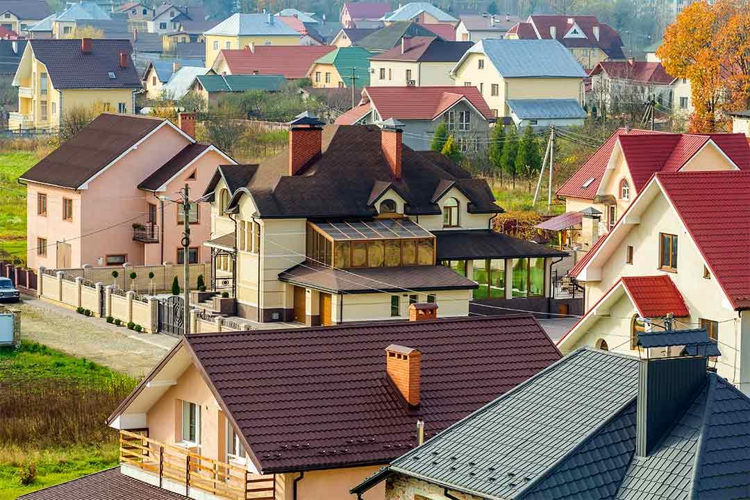 a view of different houses, each with a different type of roofing materials