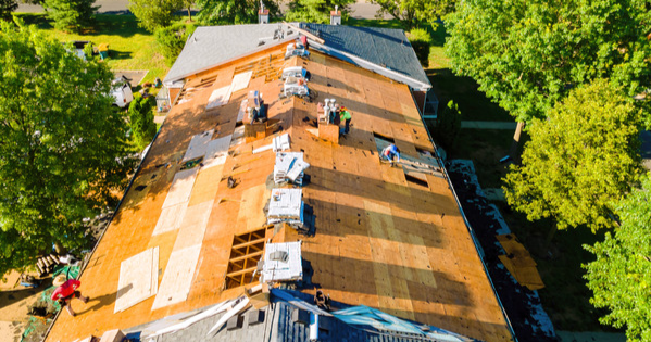 roofers expertly installing a new roof, with aligned shingles and skilled material handling