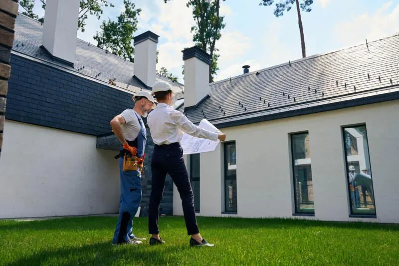 professional inspects the roof, inspecting potential issues or current damages