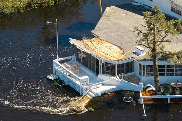 A home with a broken roof due to hurricane