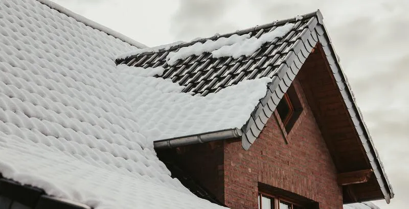 snow covering a roof on a cold winter day