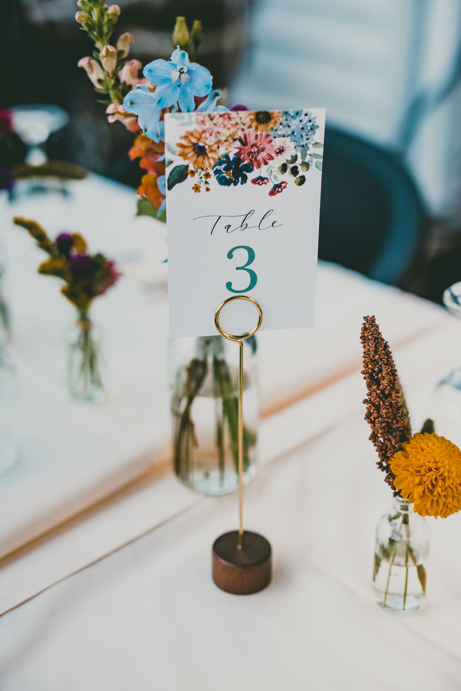 Large altar or buffet arrangement of fall flowers with dahlias, roses, amaranth, and lots of textures like mums, dahlias, sorgham