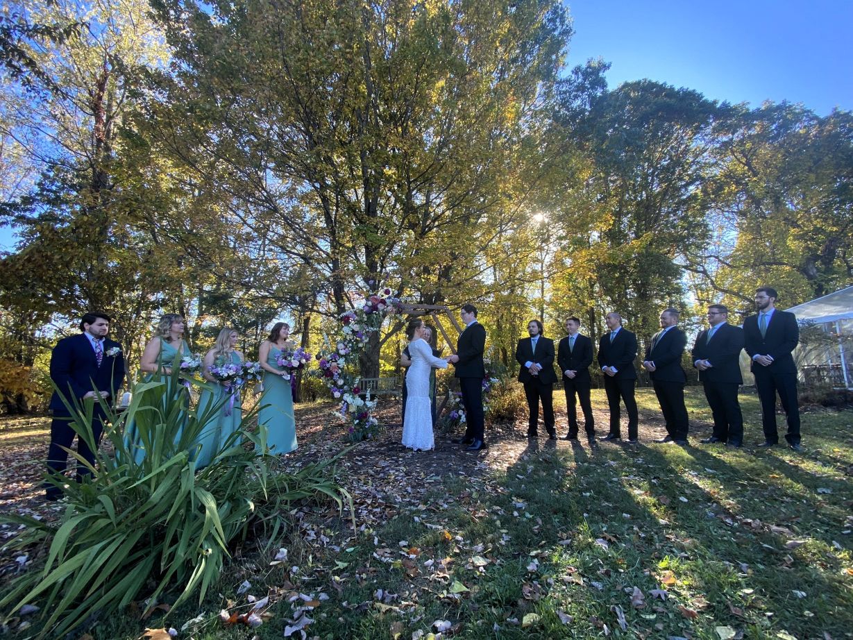 Bridal party at altar at outdoor wedding, sage green and purple, lavender