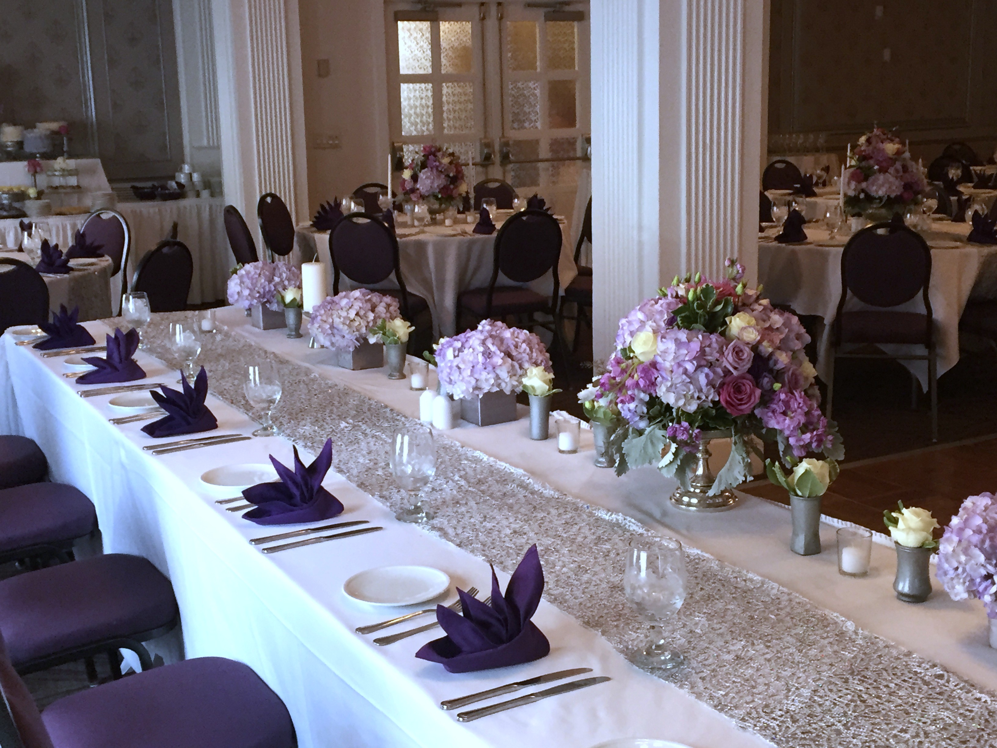 Wedding reception room with head table, shades of purple and lavender