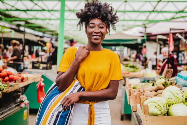A picture of a vibrant farmers' market, or a person enjoying a local fair.
