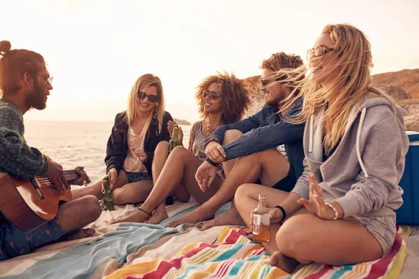 A picture of a person enjoying a beach outing or a person participating in water activities like kayaking or paddleboarding.