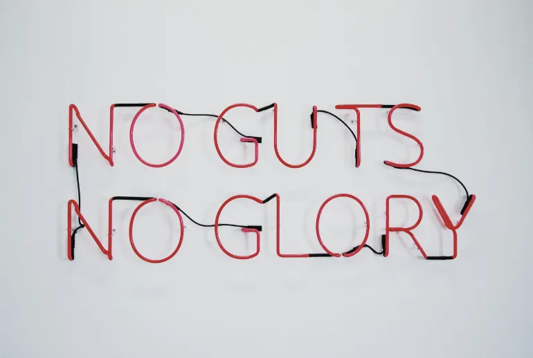 neon tubes spelling No Guts No Glory