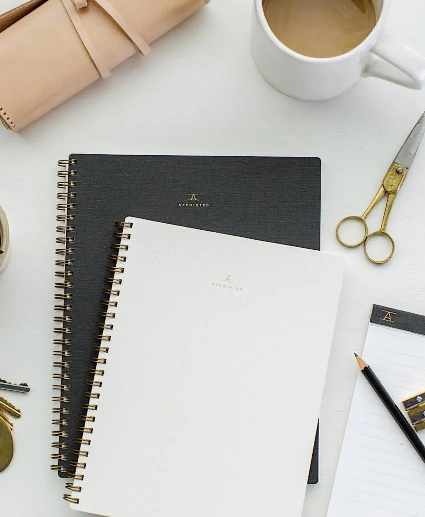 Open notebook with a move date written, symbolizing organized planning for an upcoming relocation.