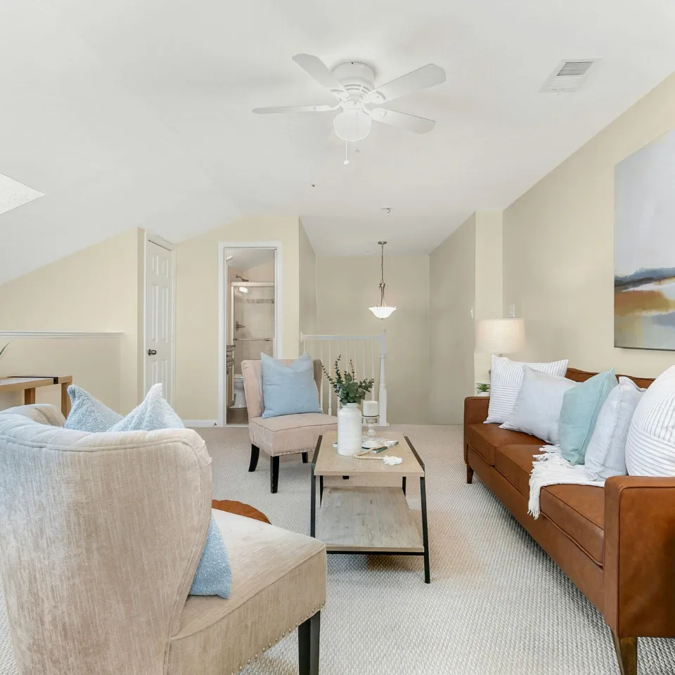Beautifully staged living room with modern furniture, warm lighting, and neutral décor—designed to help buyers envision themselves at home
