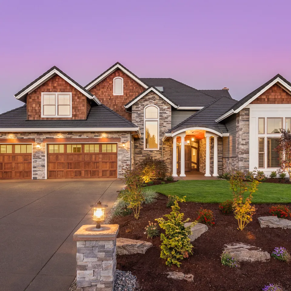 Luxury home in Georgia with elegant architecture, manicured lawn, and upscale exterior design.