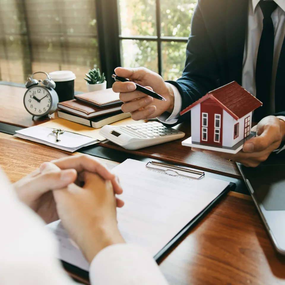 Couple reviewing mortgage options with icons for loan types in the background.