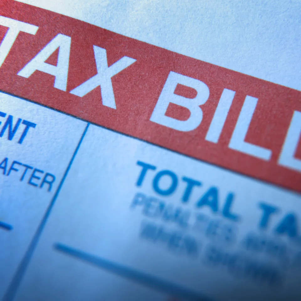 Illustration of a home surrounded by icons representing bills, taxes, insurance, and maintenance costs.