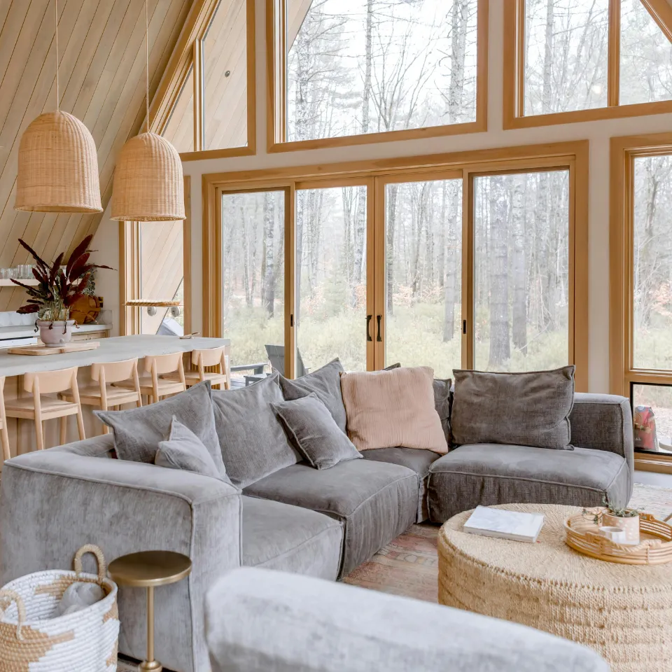 Modern vacation home by the water with large windows and scenic views.