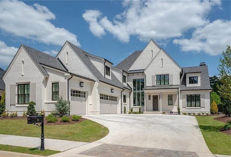 Luxury Alpharetta home with white brick exterior and modern design, ideal for empty nester homeowners considering a strategic sale.