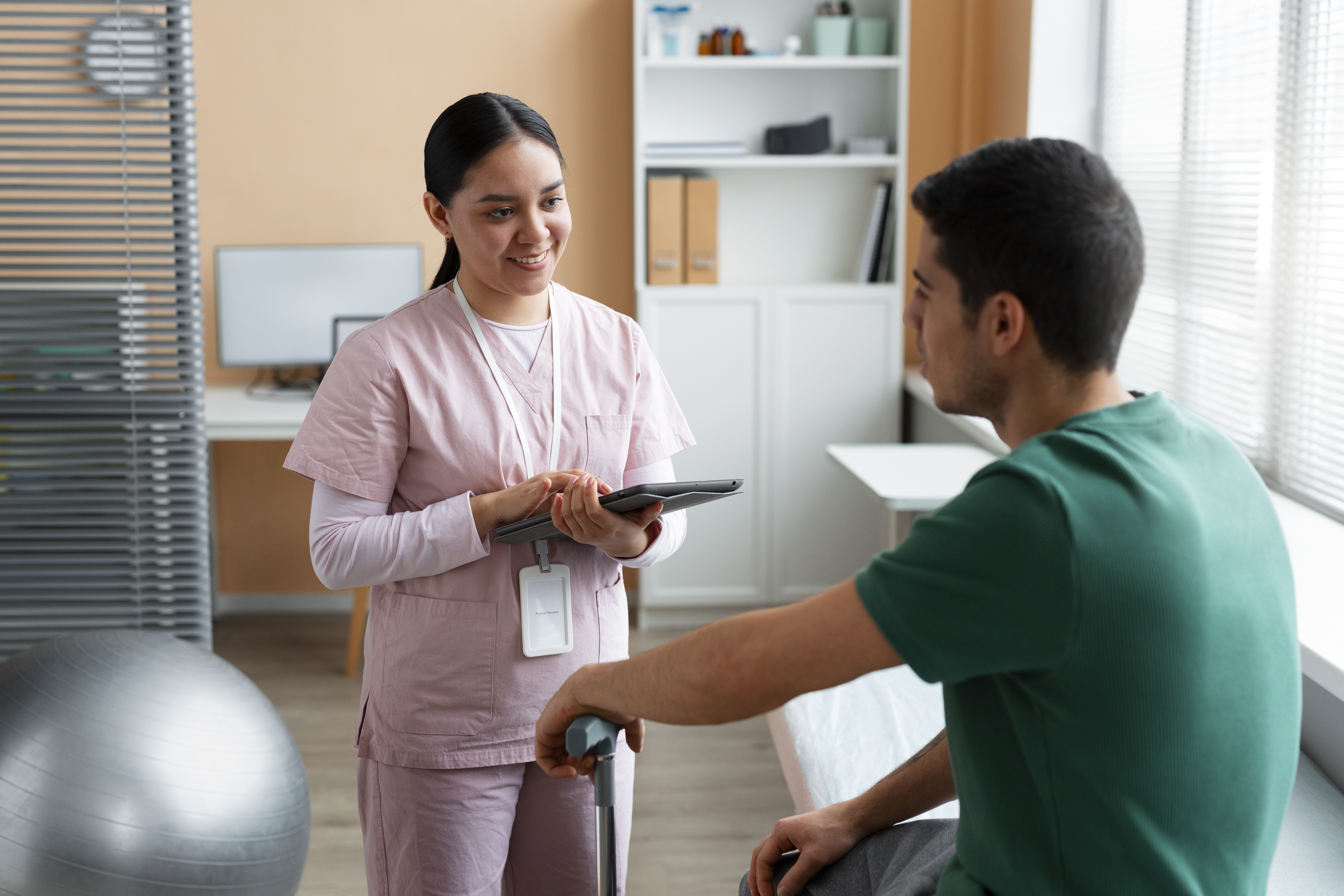 Doctor helping patient during rehabilitation
