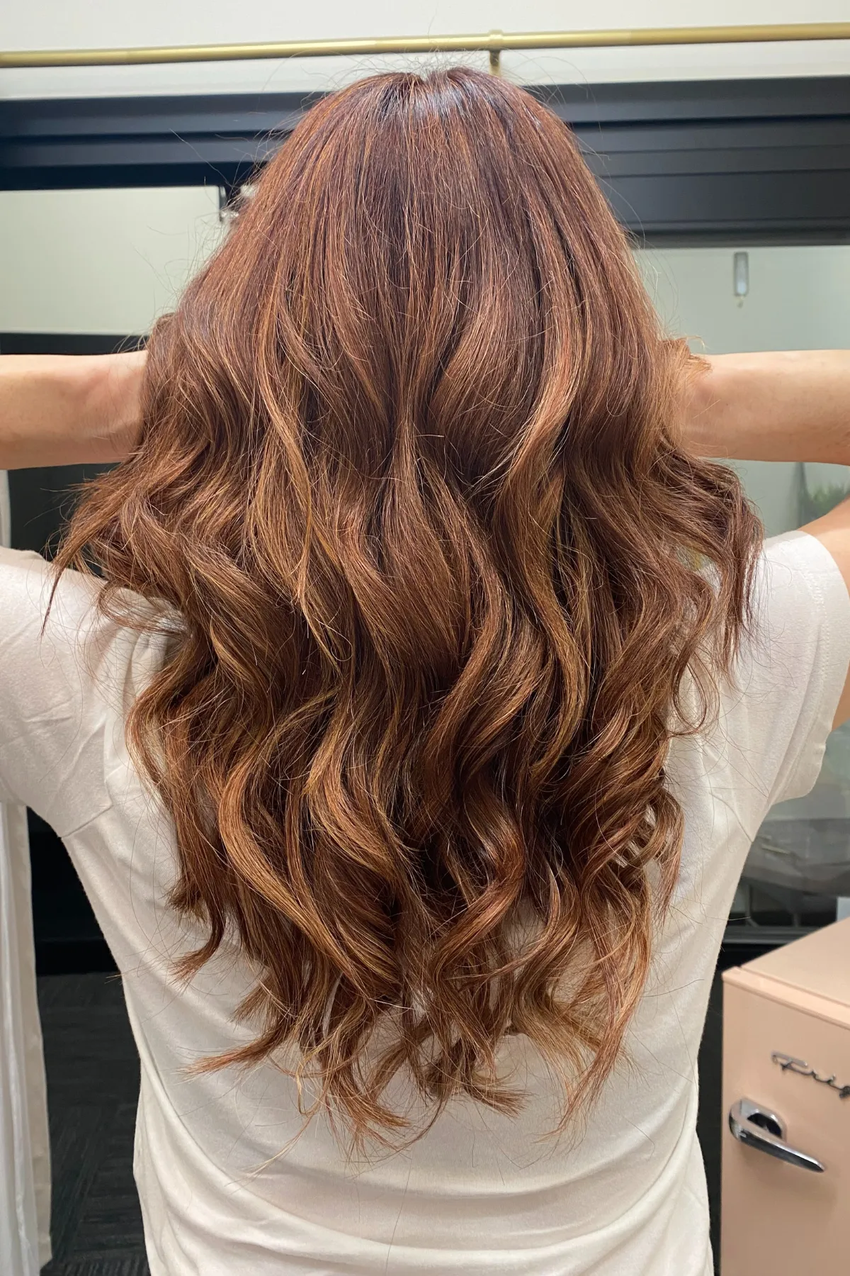 Long wavy copper brunette hair extensions installed using a Bellami Infinity Weft in the shade Firecracker at a private studio in Lancaster PA