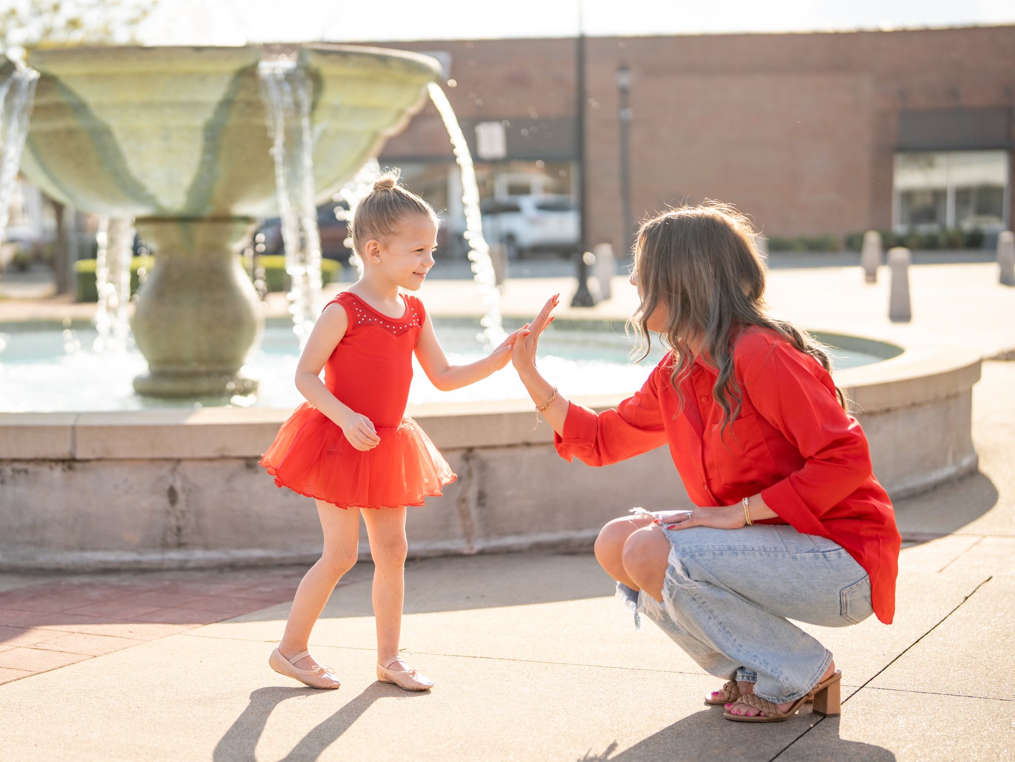 Central Arkansas Dance Studio Owner high fiving one  of their dancers.