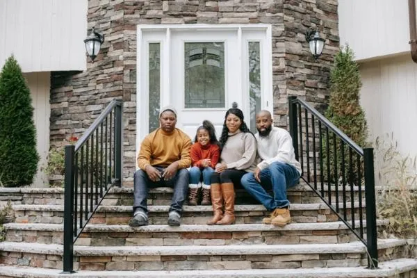 a family sitting outside a house