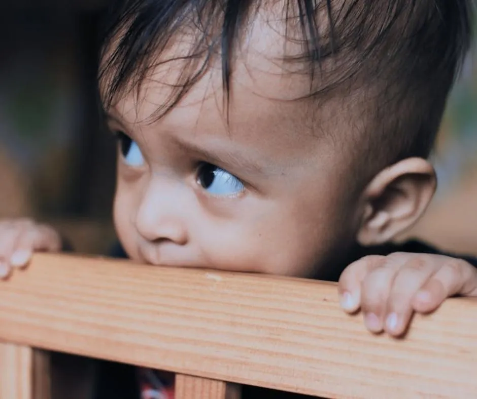 child biting the wood