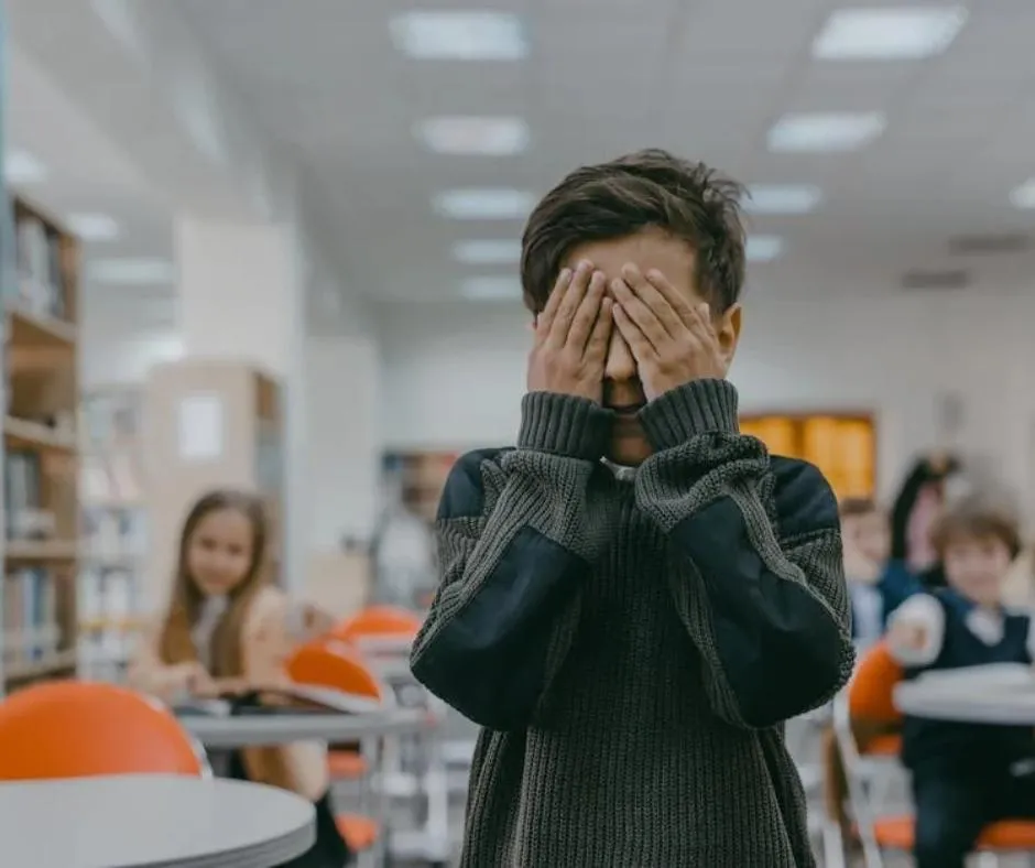 a kid in a classroom having an anxiety attack