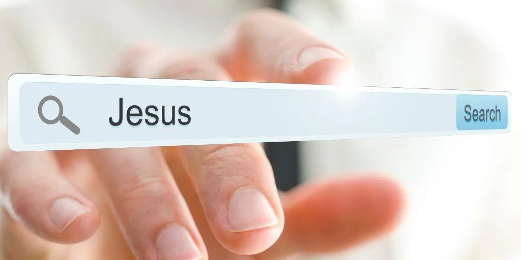 Hand pointing to search bar where the name Jesus is typed as concept for the impact of the internet on religion.