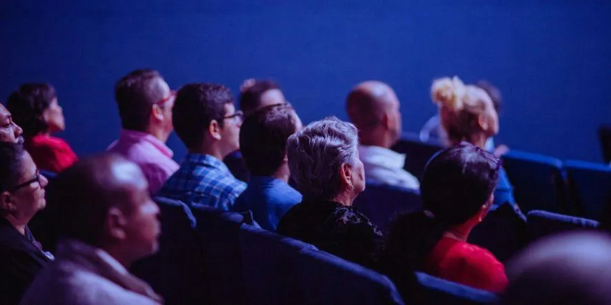 A full audience of people in seats at a church event.