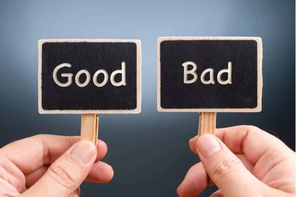 Two hands holding signs with 'good' and 'bad' text, representing the concept of good and bad debt.