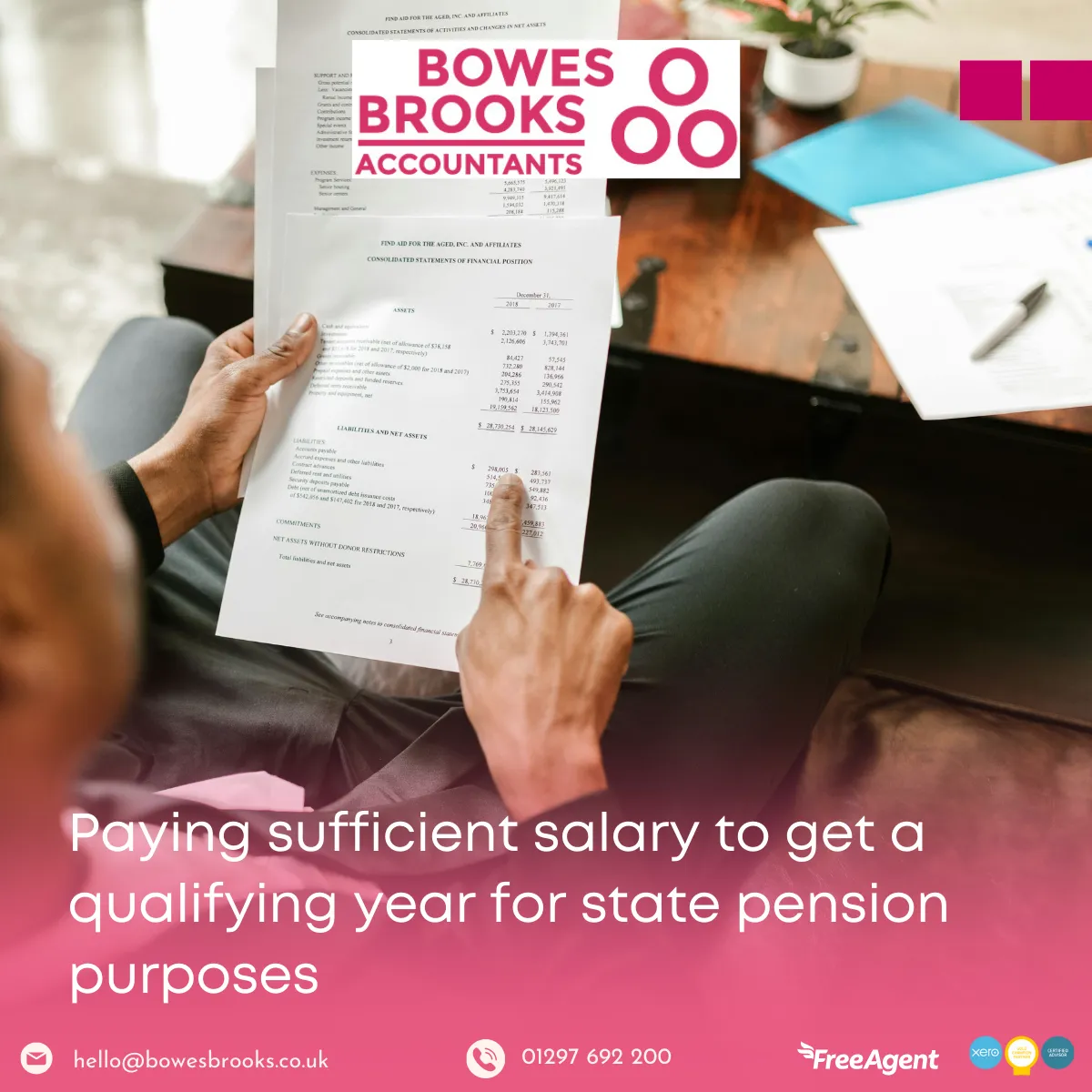 Business owner reviewing salary and dividend strategy for state pension qualification with calculator and tax documents.