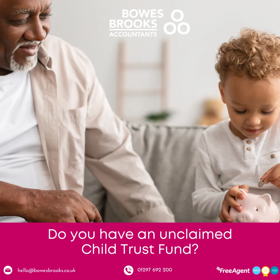 Grandfather sitting with grandchild holding a piggy bank, representing saving and unclaimed Child Trust Funds