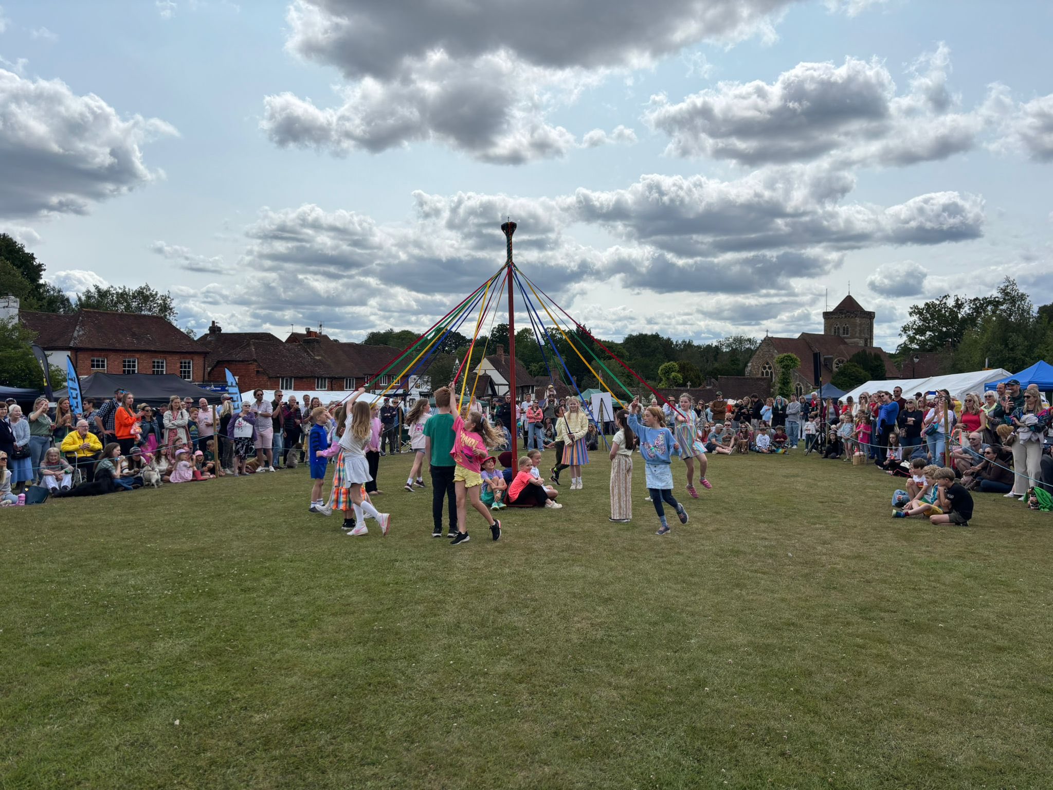 Children dancing around the maypole at Chiddingfold Village Fete