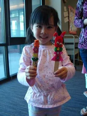 girl with popsicle stick crafts