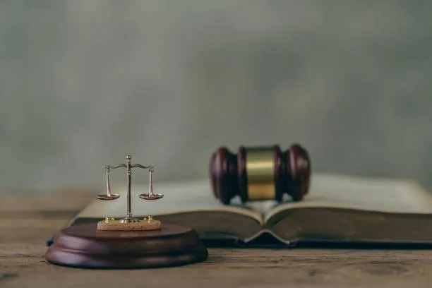 Wooden judge’s gavel beside patent documents, symbolizing legal licensing
