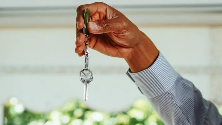 hand holding up a key