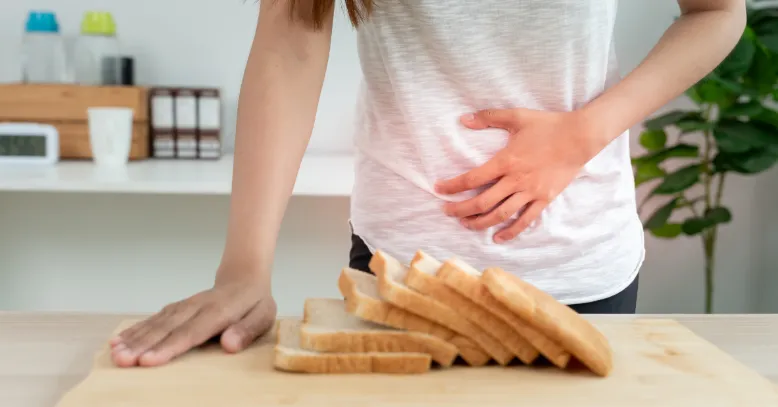 woman holding her tummy while looking at break